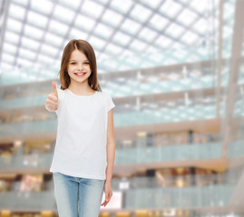 Wall Mural - smiling little girl in white blank t-shirt