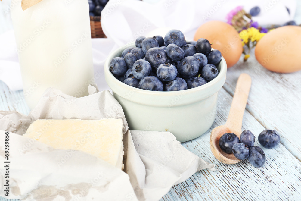 Fresh blueberries and milk products on wooden table