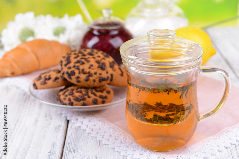 Cup of tea on table on bright background