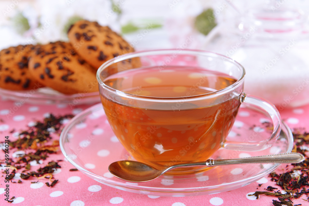 Cup of tea on table on brick wall background