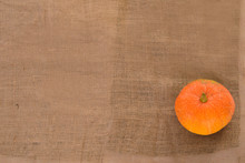 Orange Ripe Pumpkin On Linen Cloth Background