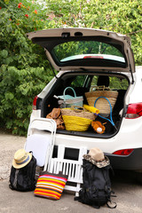 Wall Mural - Suitcases and bags in trunk of car ready to depart for holidays