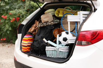 Wall Mural - Suitcases and bags in trunk of car ready to depart for holidays