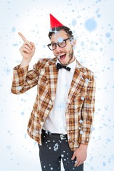 Poster - Composite image of geeky hipster in party hat pointing
