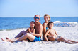 © Valua Vitaly - Smiling mother and father with children on the beach.