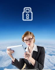 Poster - Composite image of redhead businesswoman using her tablet pc
