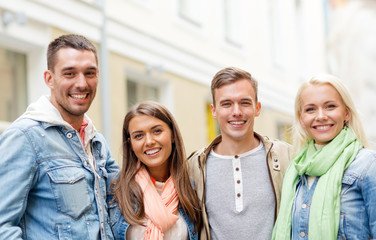 Canvas Print - group of smiling friends in city