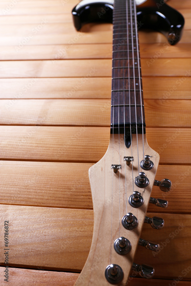 Guitar fretboard on wooden background