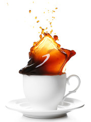 Wall Mural - Cup of coffee with splashes, isolated on white