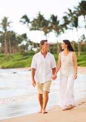 Wall Mural - Mature Couple Enjoying Walk on the Beach