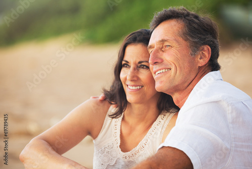 Fotografie, Obraz Mature Couple Enjoying Sunset on the Beach