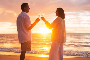 Wall Mural - Couple Enjoying Glass of Champene on the Beach at Sunset