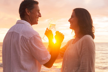 Wall Mural - Couple Enjoying Glass of Champene on the Beach at Sunset