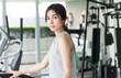 © siraphol - Woman workout at fitness