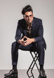 © Viorel Sima - elegant man with glasses sitting on chair