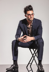 Poster - fashion man in suit sitting and looks to  side