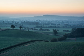 Wall Mural - Stunning sunrise over fog layers in countryside landscape