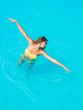 © Netfalls - A girl is relaxing in a swimming pool