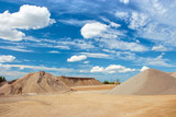 Fototapeta  - Sand and gravel quarry construction site with cloudy blue sky
