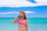 Fototapeta  - Adorable little girl have fun at tropical beach during vacation