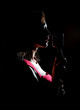 © M-Production - Silhouette of woman singing into vintage microphone.