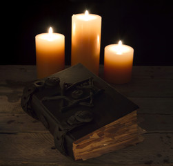 Black magic book with candles