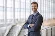 © elnariz - Portrait of happy businessman at an airport terminal