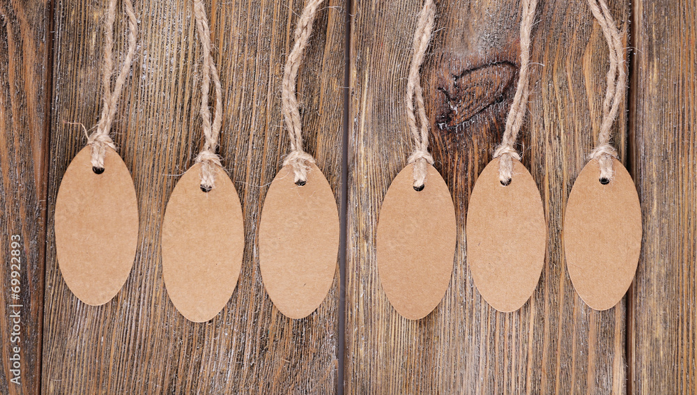 Brown tags on wooden background