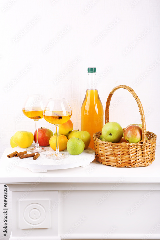 still life with apple cider and fresh apples on wooden table