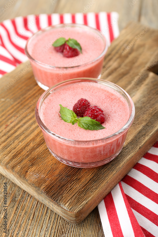 Delicious berry mousse in bowls on table close-up