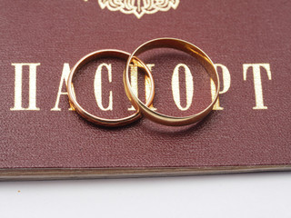 Sticker - wedding rings and a Russian passport on white background