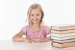 © BlueSkyImages - little girl studying literature and smiling.