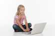 © BlueSkyImages - Cute little girl sitting on floor.