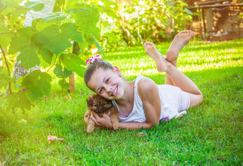 Portrait of pretty girl with a pekinese puppy