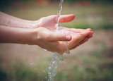 Fototapeta Łazienka - Woman's hands with water splash