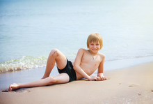 Boy On A Beach In Sand