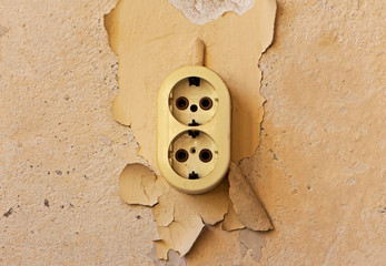 Wall Mural - Old electrical outlet on decrepit wall