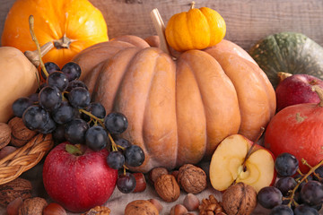  decorative pumpkins and fruits on wood background