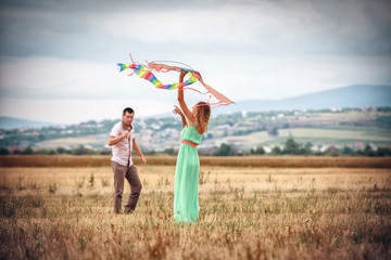 happy young couple flying a kite