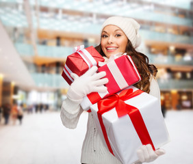 Sticker - smiling young woman in santa helper hat with gifts