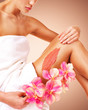 © Valua Vitaly - The woman with a beautiful with flowers body using a scrub
