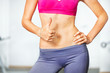 © Dmytro Panchenko - Closeup of young slim woman with six-pack torso.
