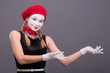 © zinkevych - Portrait of female mime with red hat and white face grimacing wi