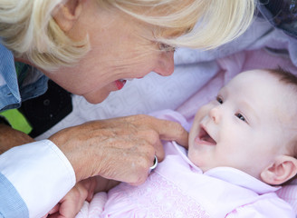 Happy grandmother smiling with baby girl