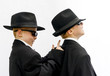 Twin boys dressed as gangsters.