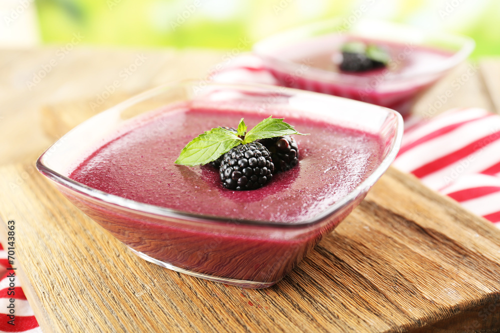 Delicious berry mousse in bowls on table close-up