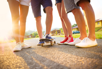 Young peoples legs with skateboard