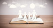 © ra2 studio - Cardboard figures of the family on opened book