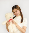 © tropper2000 - asian teen holding a  bear doll.