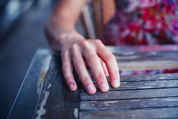 Woman resting hand on table